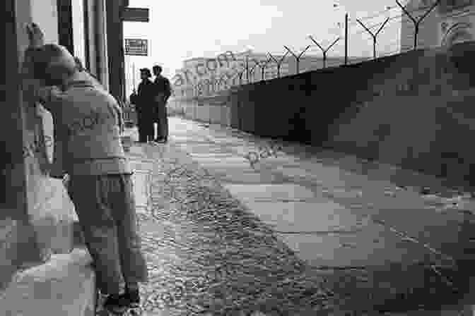 A Black And White Photograph Of A Family Standing In Front Of A Wall In East Germany. Red Love: The Story Of An East German Family